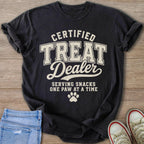 Black t-shirt with text "Certified Treat Dealer, Serving Snacks One Paw At A Time".