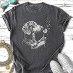 Dachshund holding a dandelion with blowing seeds, charcoal t-shirt.