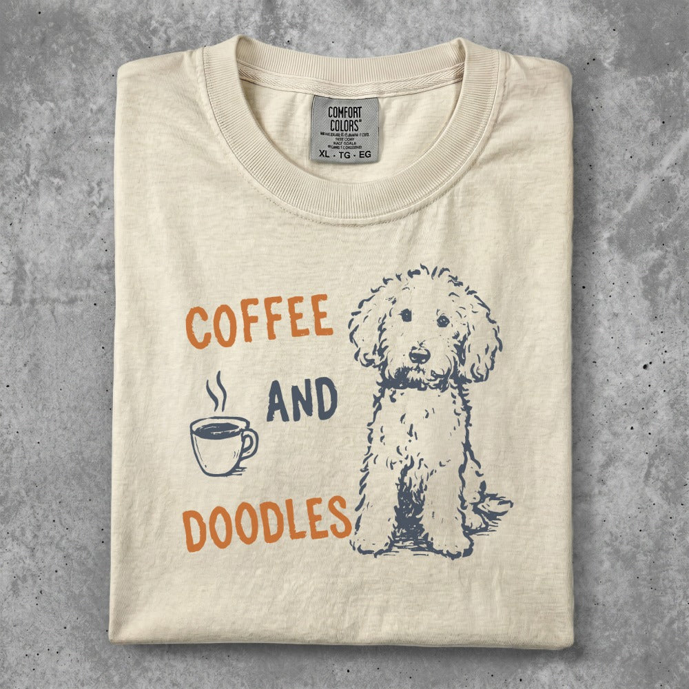 Cream t-shirt with "COFFEE AND DOODLES" and a doodle dog illustration.