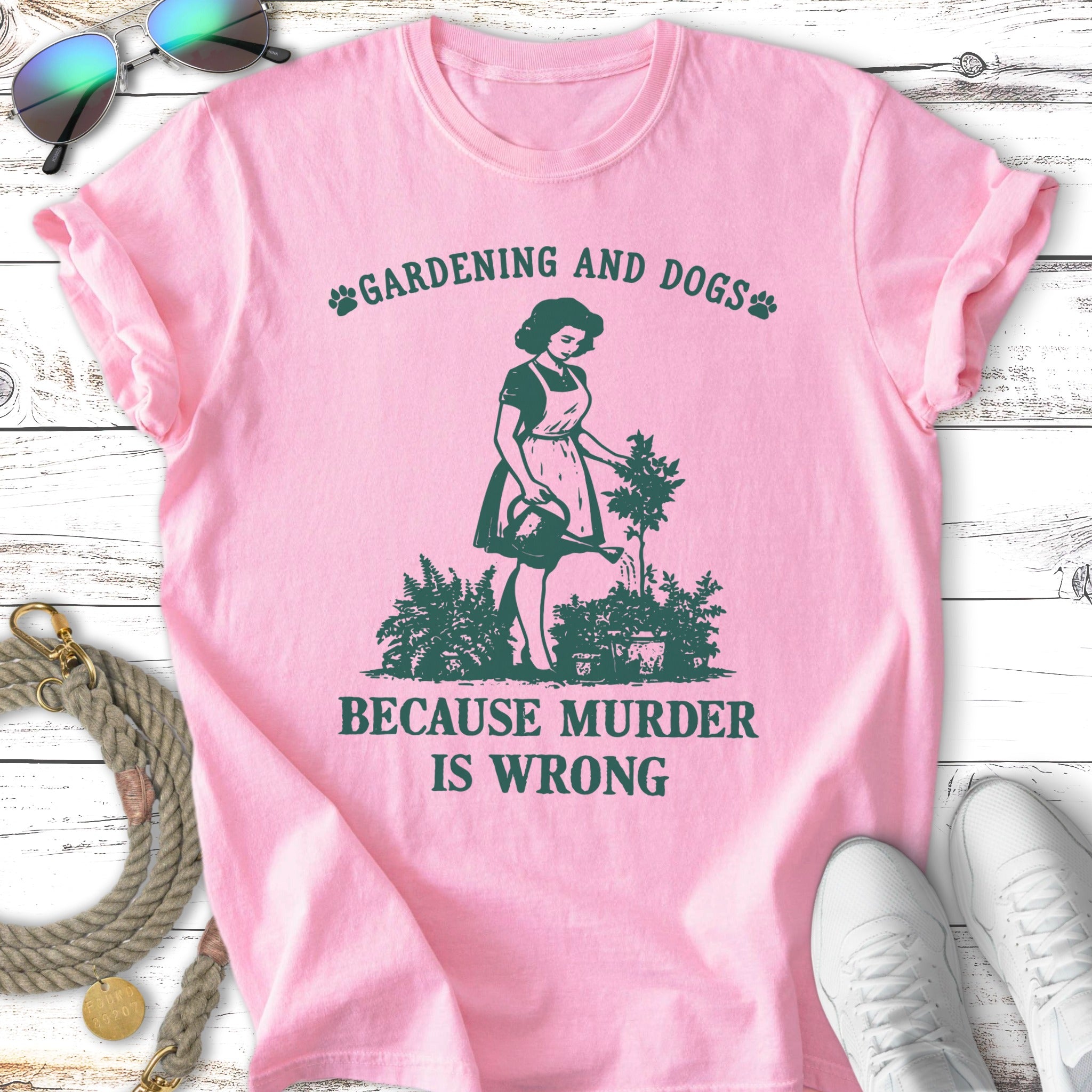 Pink t-shirt with "Gardening and Dogs" and "Because Murder Is Wrong" text.