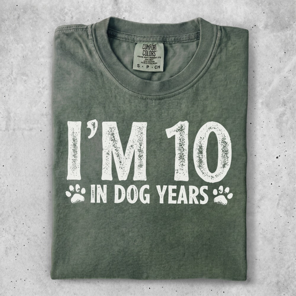Green t-shirt with "I'm 10 in dog years" graphic.