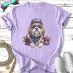 Shih Tzu dog wearing USA bandana, sunglasses, and hat, with patriotic floral accents.