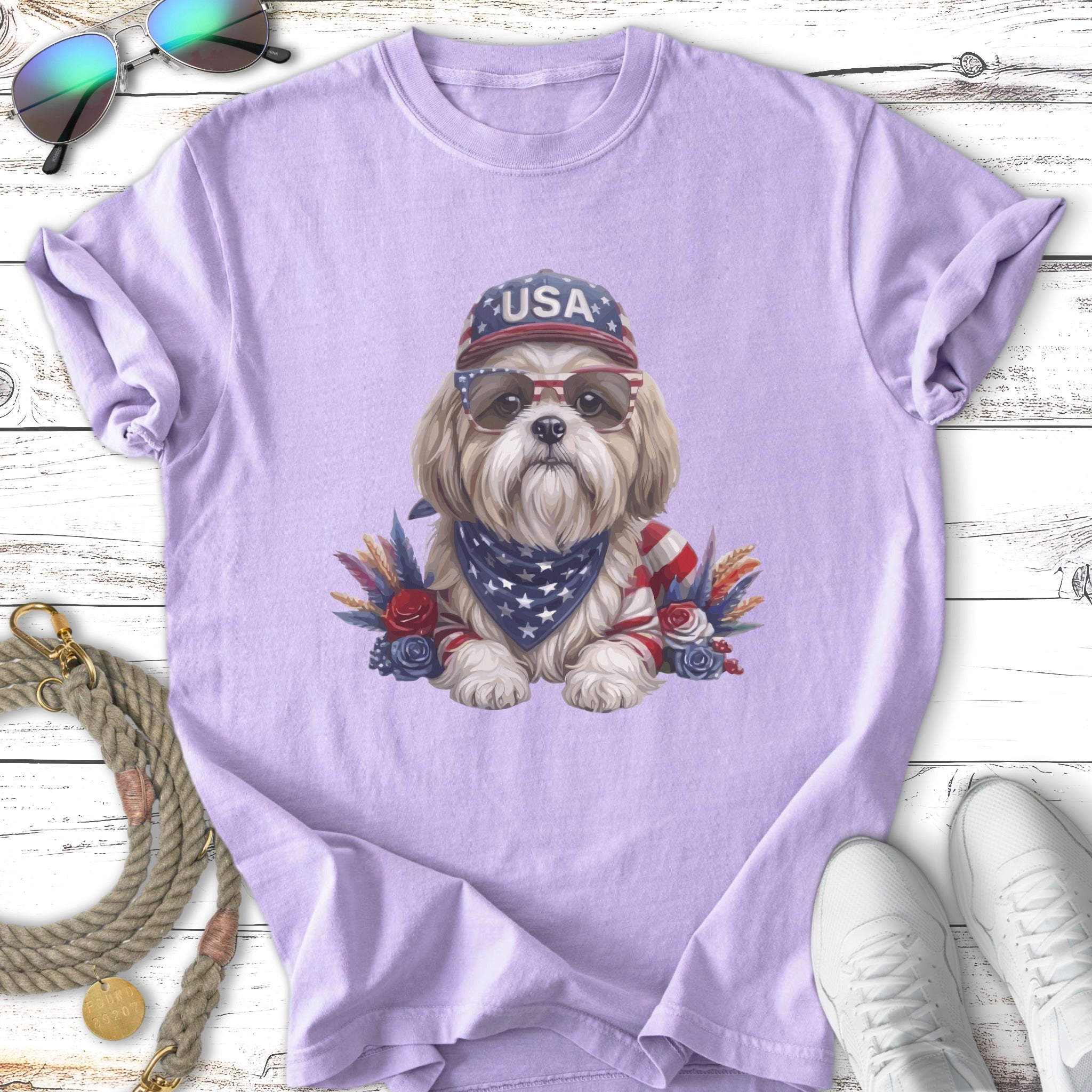 Shih Tzu dog wearing USA bandana, sunglasses, and hat, with patriotic floral accents.