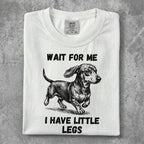 White t-shirt with dachshund graphic and text "WAIT FOR ME I HAVE LITTLE LEGS".