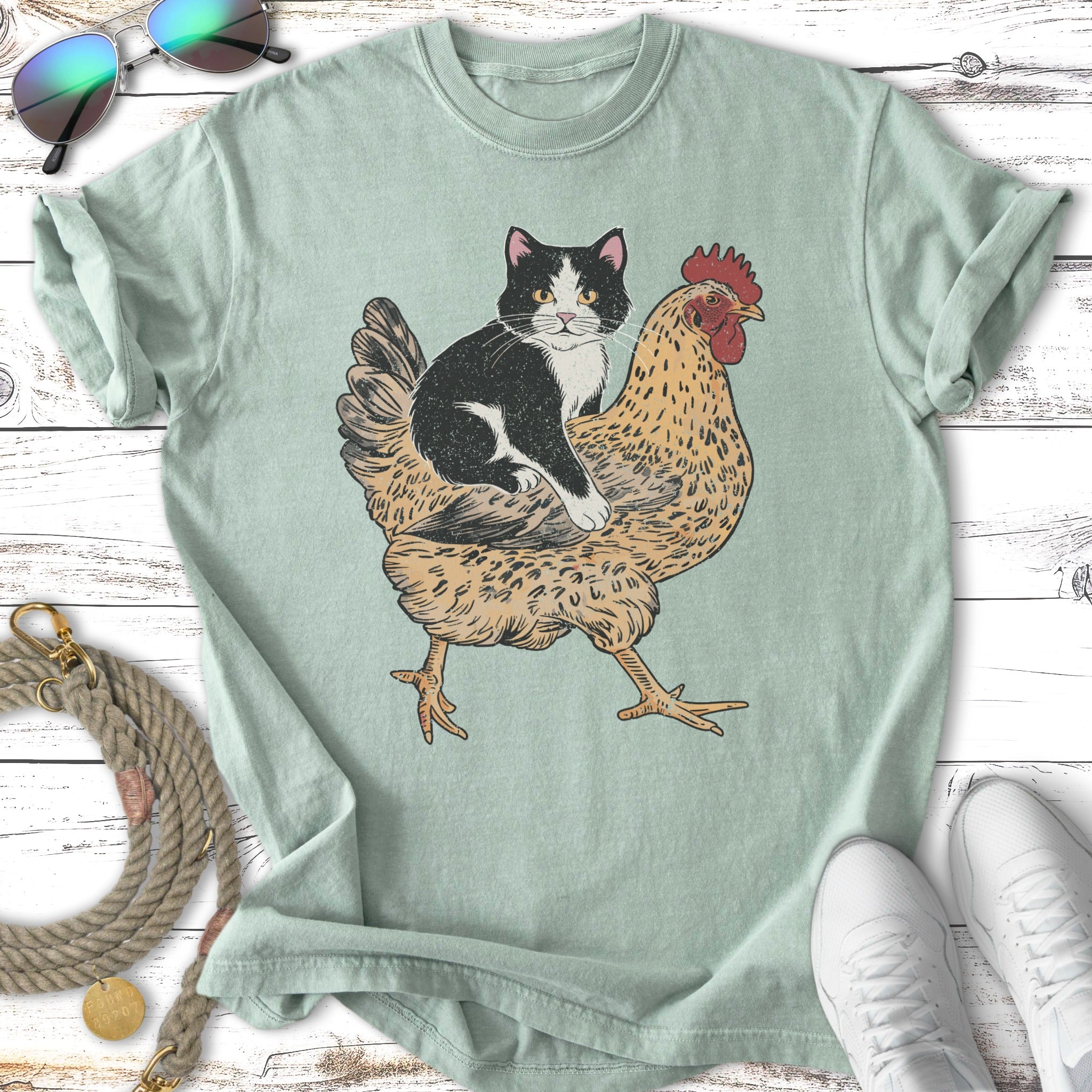 Black and white cat sitting on a stylized brown chicken.