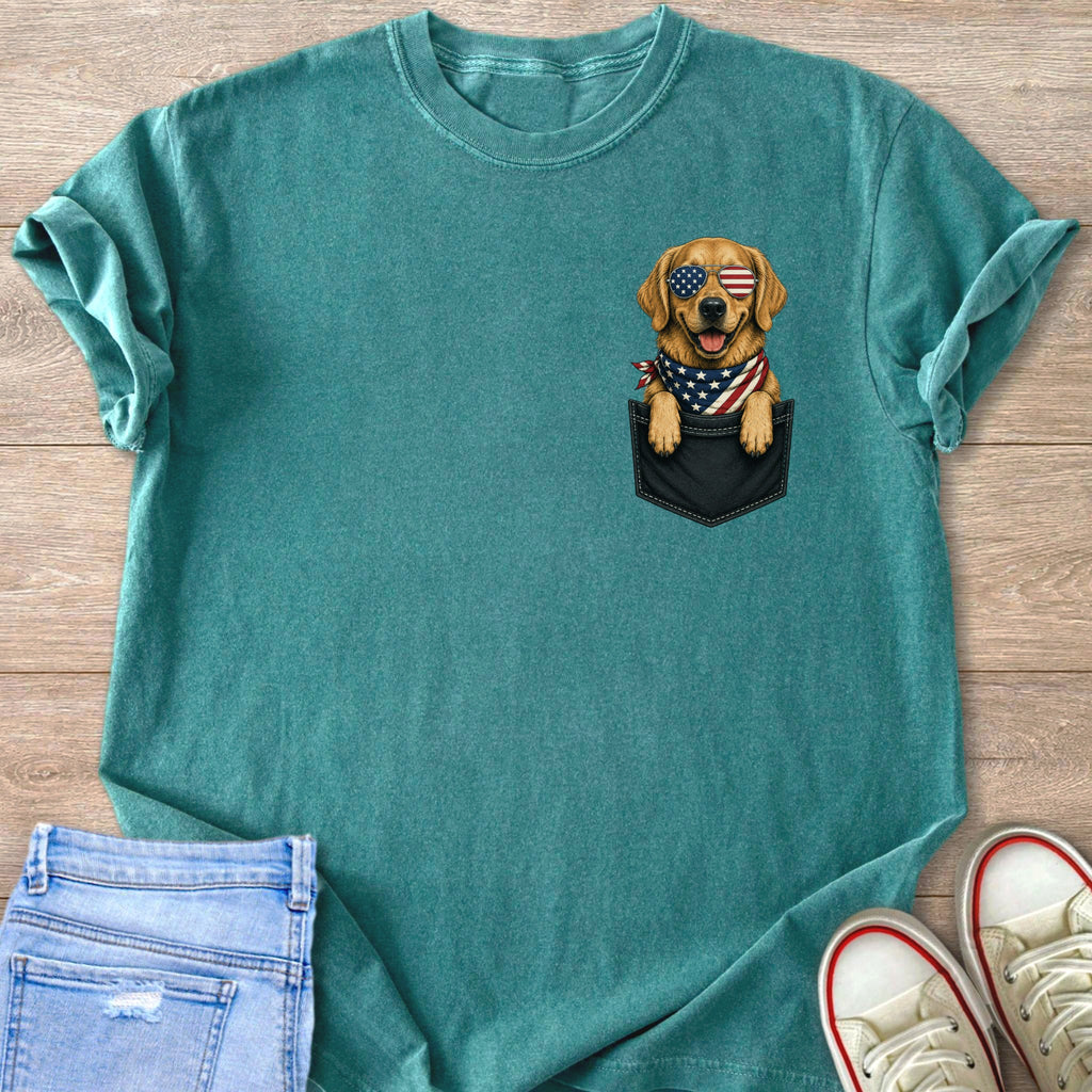Golden Retriever dog wearing American flag bandana and sunglasses peeking from pocket.