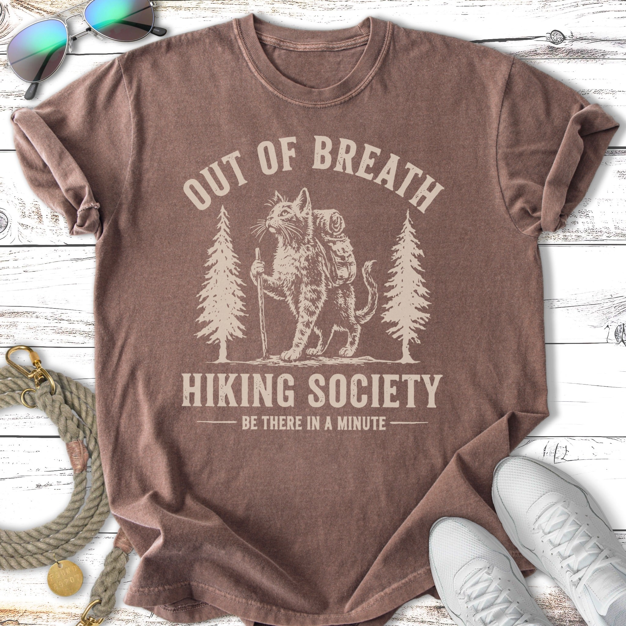 T-shirt with cat hiking graphic and text "OUT OF BREATH HIKING SOCIETY".