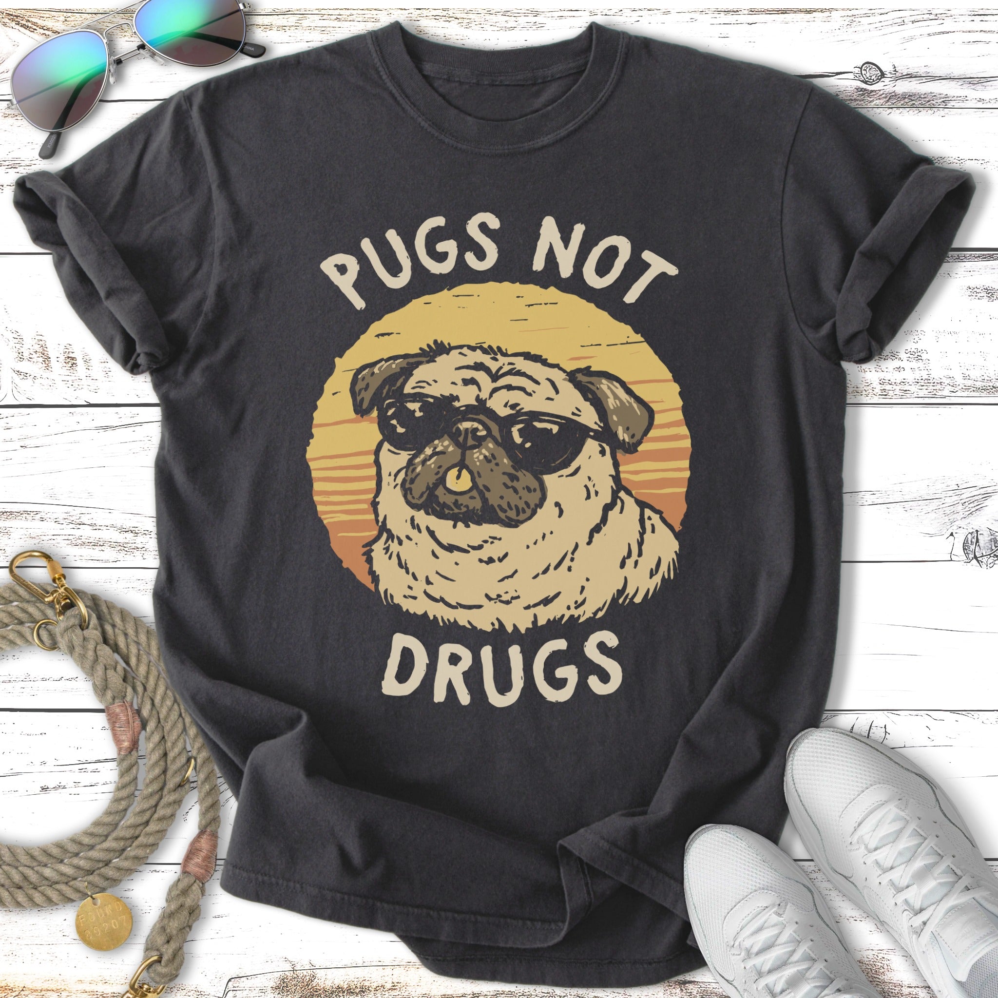 Pugs not drugs text with pug wearing sunglasses on a t-shirt.