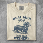 T-shirt with dachshund and "Real Men Play With Their Wieners" text.