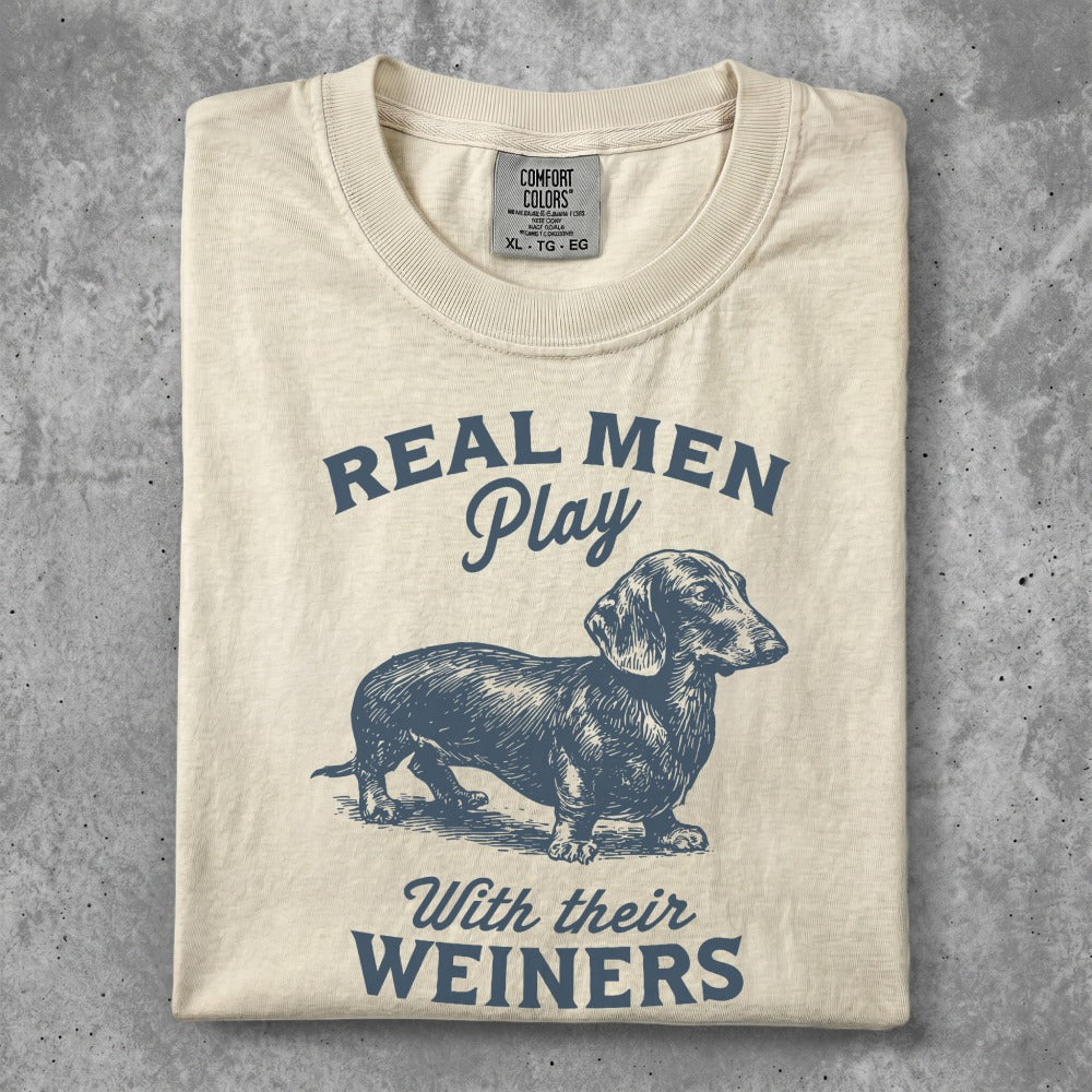 T-shirt with dachshund and "Real Men Play With Their Wieners" text.