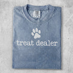 Blue t-shirt with "treat dealer" and paw print graphic.