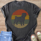 Dark t-shirt with black pug silhouette on distressed vintage sunset background.