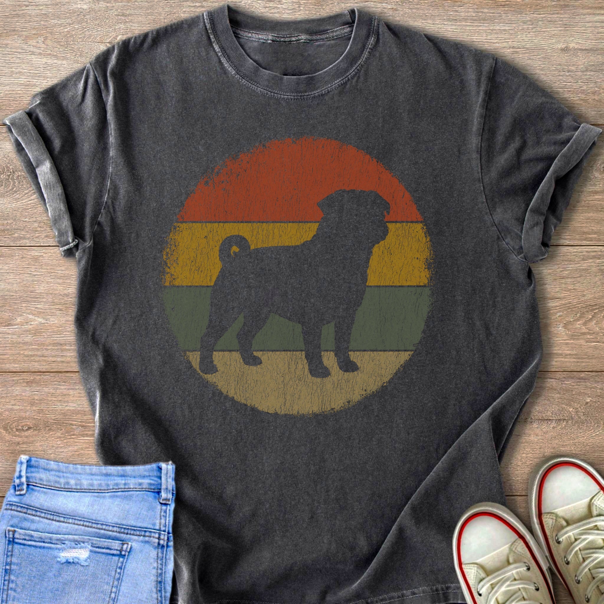 Dark t-shirt with black pug silhouette on distressed vintage sunset background.