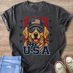 Golden Retriever dog wearing American flag bandana, sunglasses, and baseball cap with text USA.