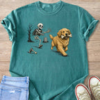 Skeleton chasing a golden retriever carrying a bone in a graveyard scene.