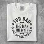 White t-shirt with "Fur Dad The Man The Myth The Snack Dealer" text and paw prints.