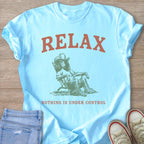 Light blue t-shirt with "RELAX" and an illustration of a dog wearing a cowboy hat.