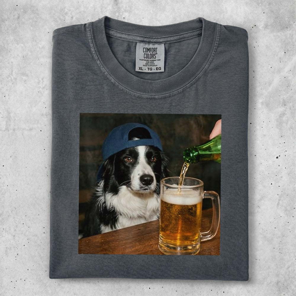 Border collie wearing a blue baseball cap, looking at a mug of beer being poured.