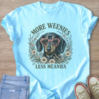 Light blue t-shirt with a dachshund wearing heart sunglasses and text saying "More Weenies Less Meanies".