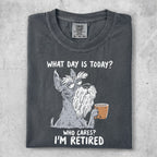 Charcoal t-shirt with a cartoon schnauzer holding coffee, reading "What day is today? Who cares? I'm retired."