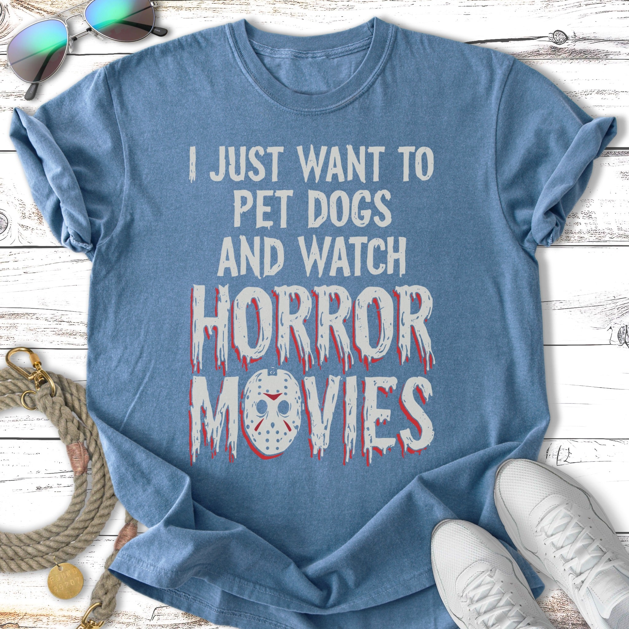 Blue t-shirt with "I just want to pet dogs and watch horror movies" in distressed red font.