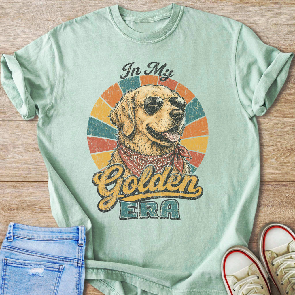 Mint green t-shirt with graphic of dog wearing sunglasses and bandana, text "In My Golden ERA".