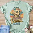 Mint green t-shirt with graphic of dog wearing sunglasses and bandana, text "In My Golden ERA".