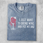 Grey t-shirt with "I JUST WANT TO DRINK WINE AND PET MY DOG" text and wine glass graphic.