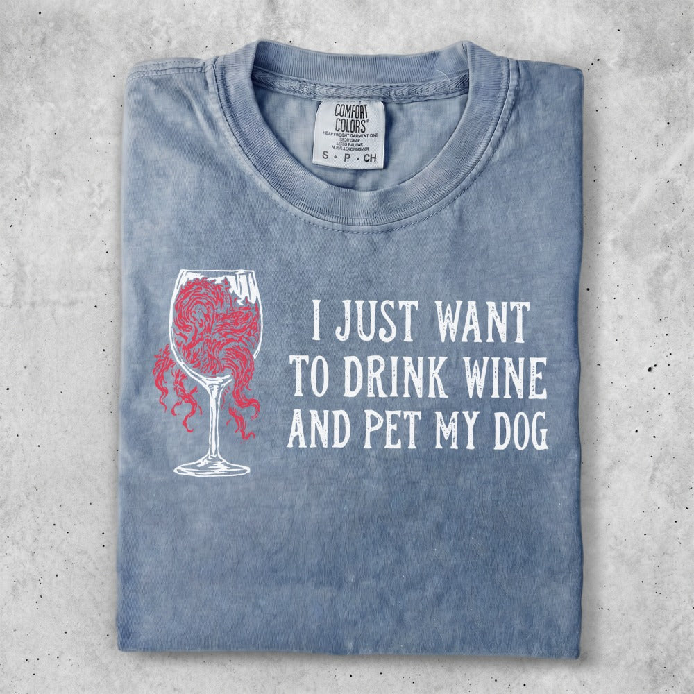 Grey t-shirt with "I JUST WANT TO DRINK WINE AND PET MY DOG" text and wine glass graphic.