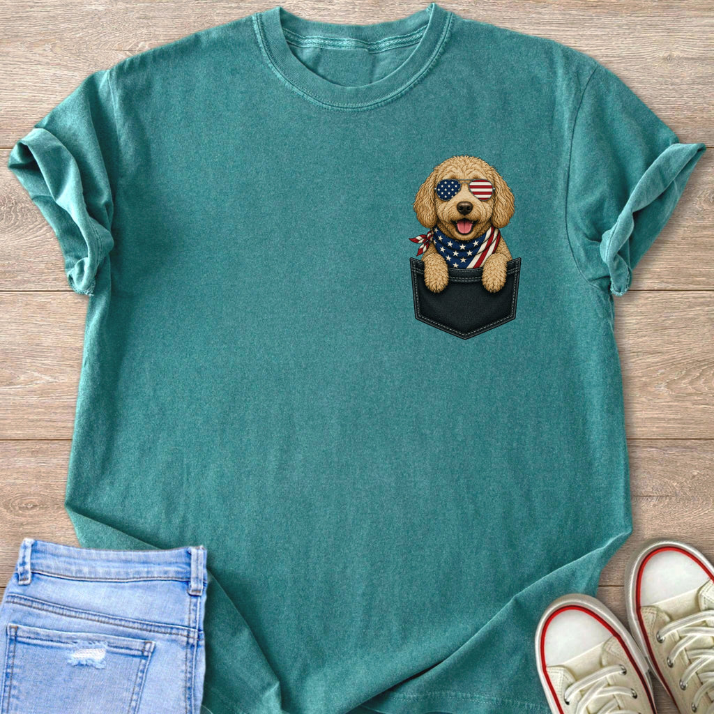 Teal t-shirt with a cartoon dog wearing American flag sunglasses and bandana in a pocket.