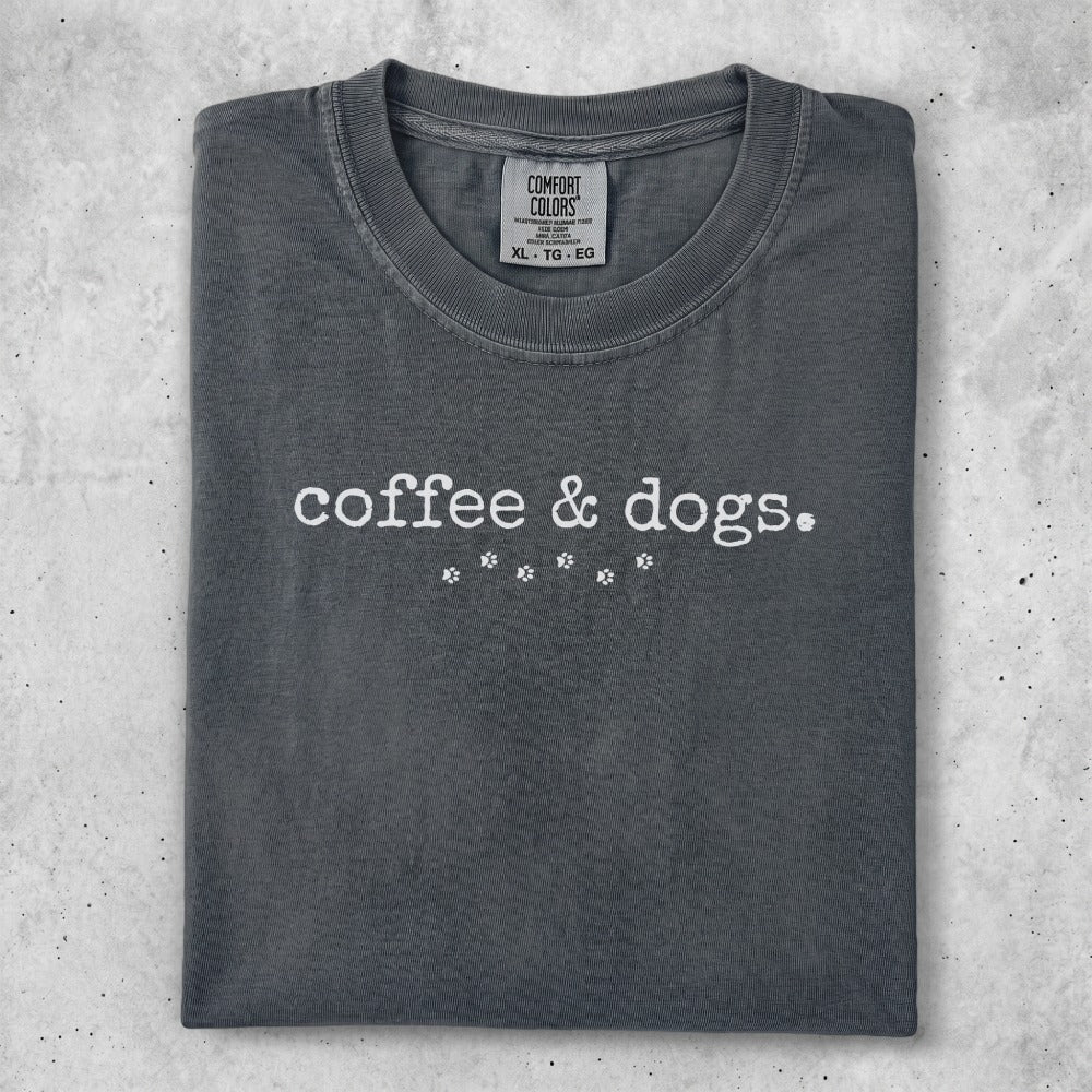 Charcoal t-shirt with "coffee & dogs." text and paw print design.