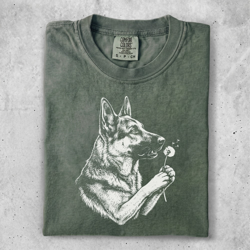 German Shepherd with dandelion on olive green t-shirt.