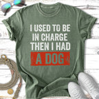 Green t-shirt with white text: "I USED TO BE IN CHARGE THEN I HAD A DOG".