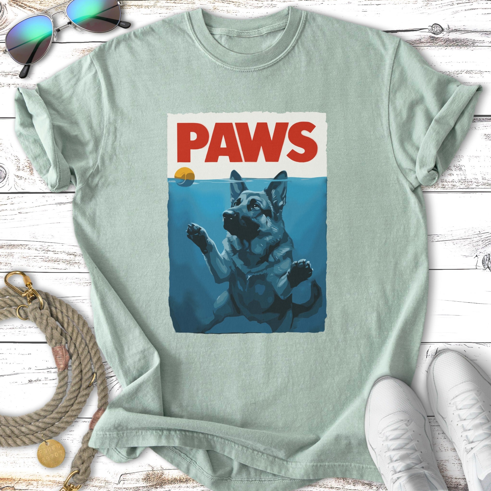German Shepherd dog swimming with "PAWS" text above water.