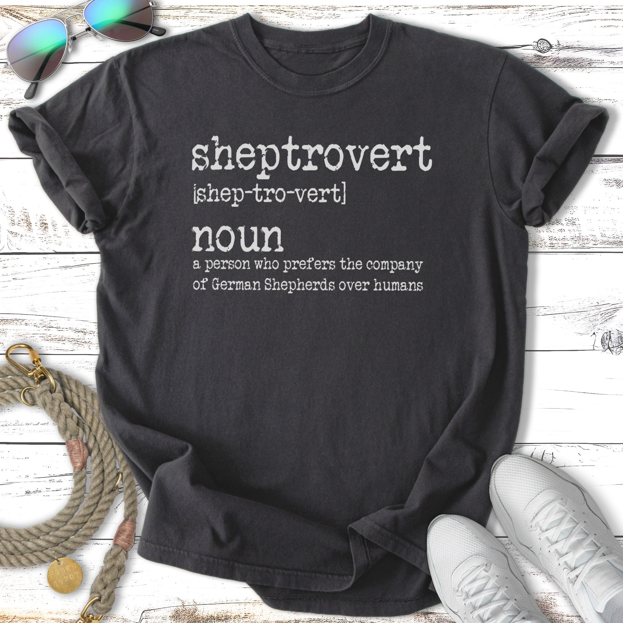 Dark t-shirt with white text defining "sheptrovert" as a German Shepherd lover.