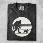T-shirt with Bigfoot walking a dog graphic, Comfort Colors XL tag.