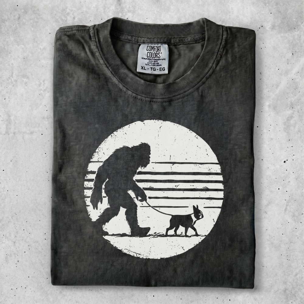 T-shirt with Bigfoot walking a dog graphic, Comfort Colors XL tag.