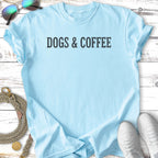 Light blue t-shirt with "DOGS & COFFEE" text, sunglasses and sneakers.