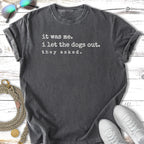 Dark grey t-shirt with text "it was me. i let the dogs out. they asked."