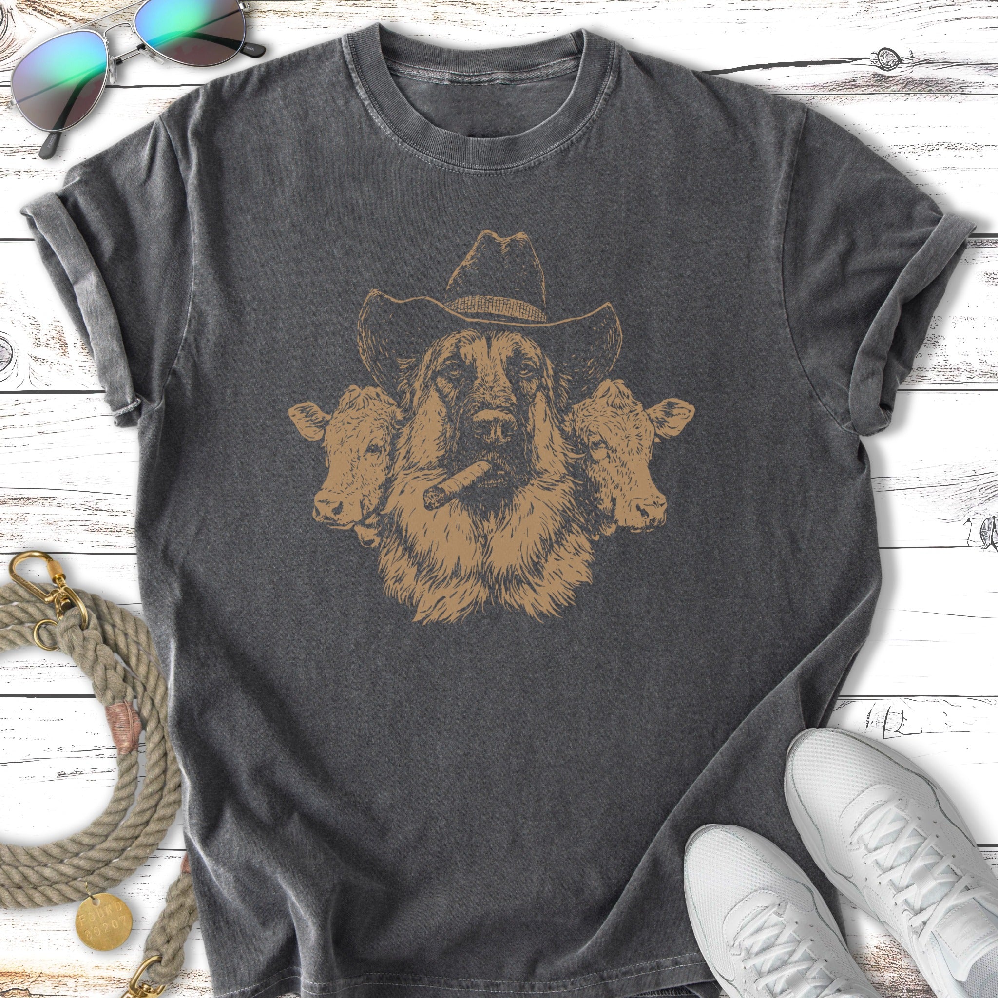 Dog wearing a cowboy hat with two cows flanking its head.