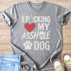 Gray t-shirt with text: middle finger, heart, skull, paw print, and "I Fucking My Asshole Dog".