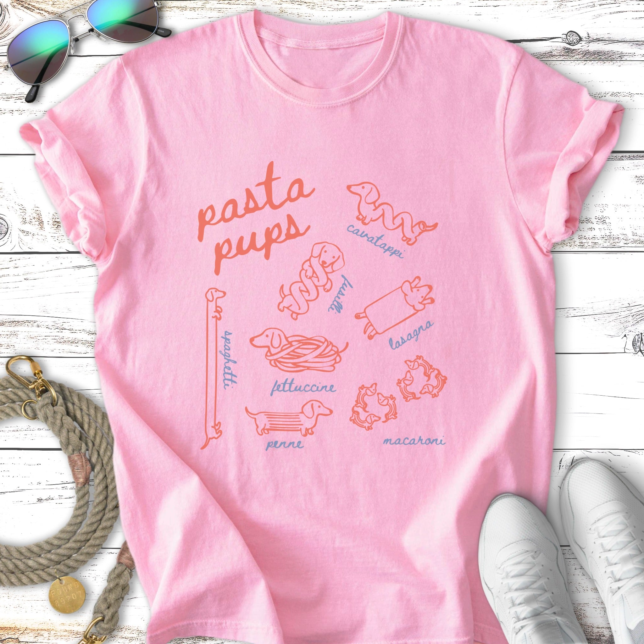 Pink t-shirt with illustrations of dachshunds in pasta shapes.
