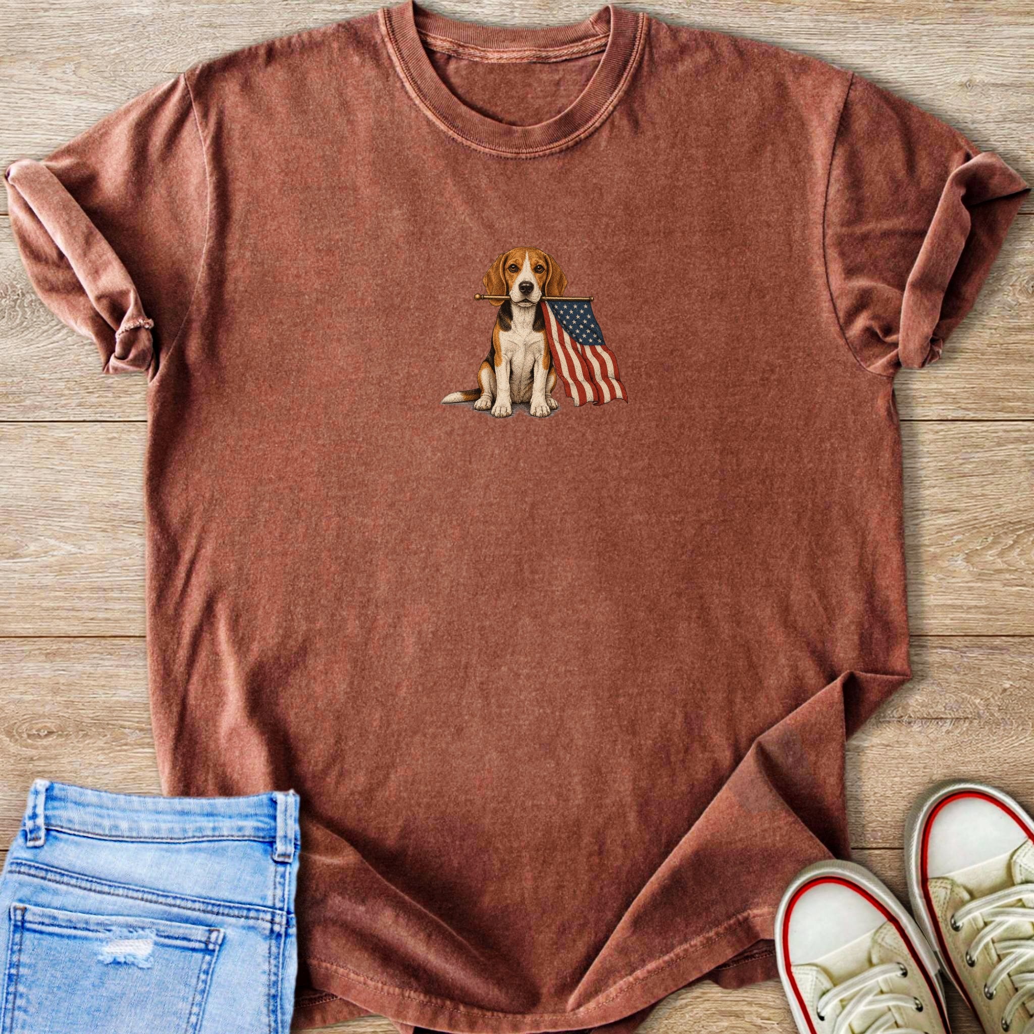 Beagle dog with American flag on a rust-colored t-shirt, styled with jeans and sneakers.