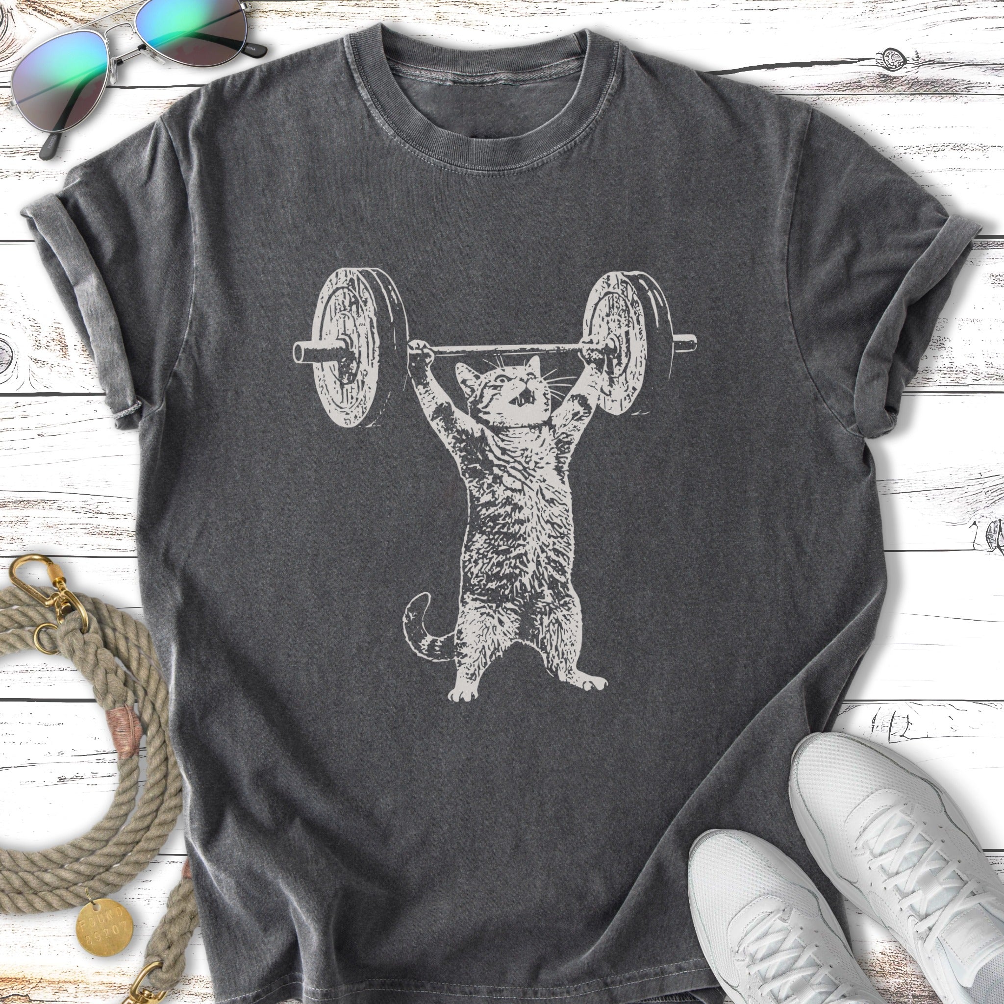 Cat lifting barbell, charcoal t-shirt.