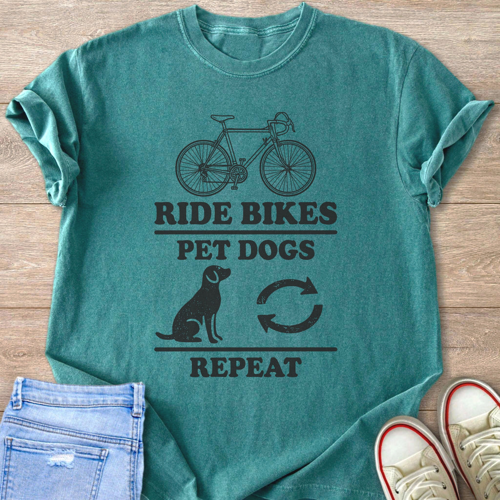 Teal t-shirt with "Ride Bikes Pet Dogs Repeat" text and graphics.