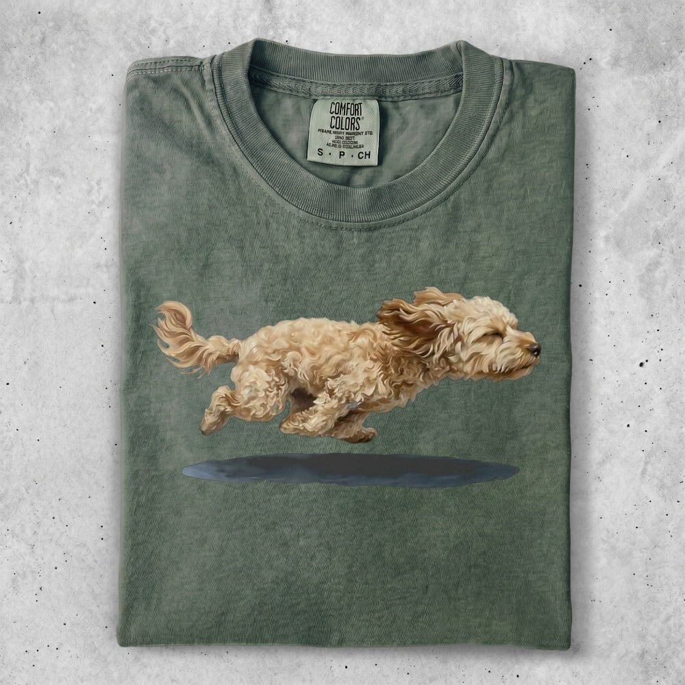 T-shirt with a brown dog running over a puddle.