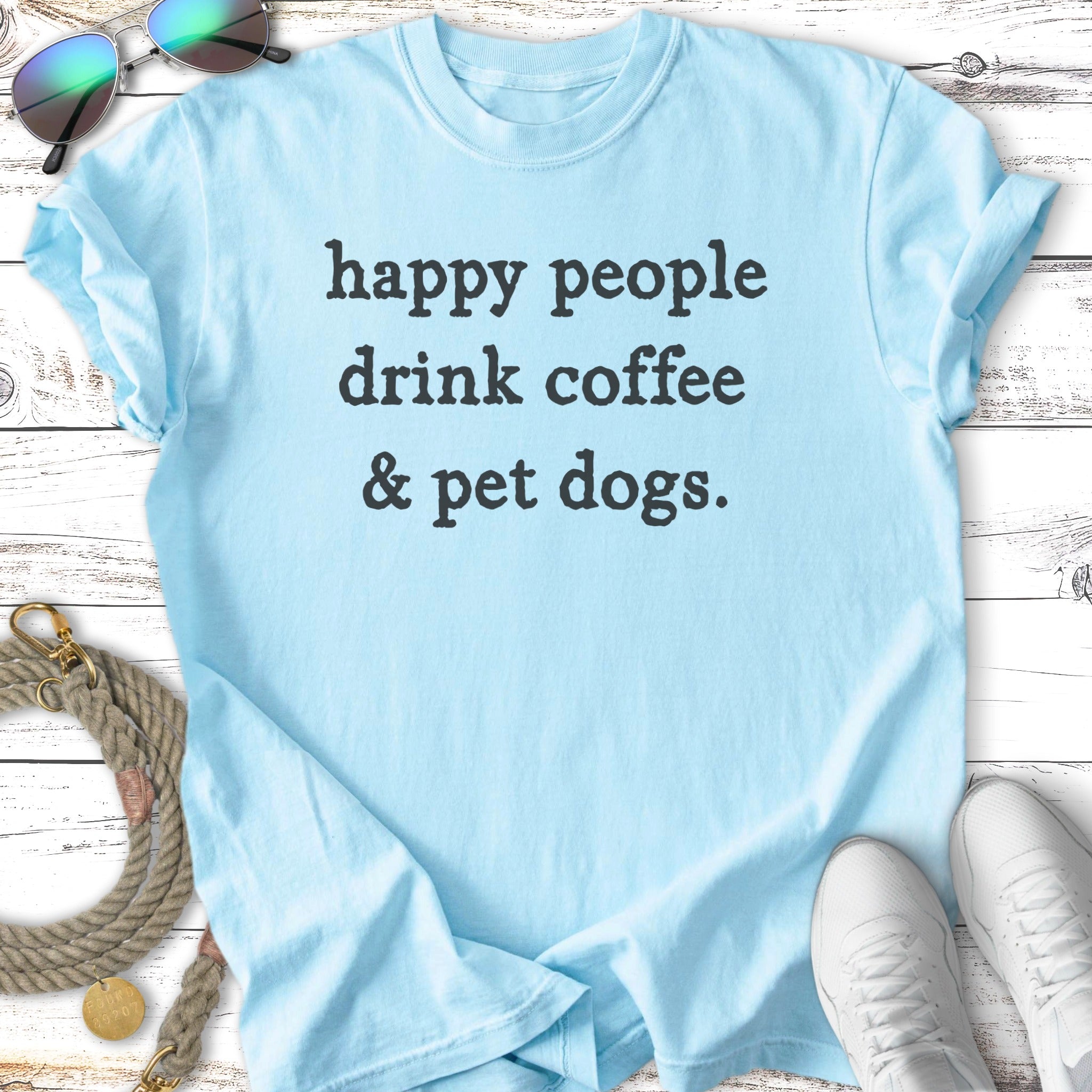 Light blue t-shirt with text "happy people drink coffee & pet dogs."