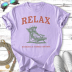 Lilac t-shirt with graphic of dog relaxing in chair, text: RELAX, NOTHING IS UNDER CONTROL.
