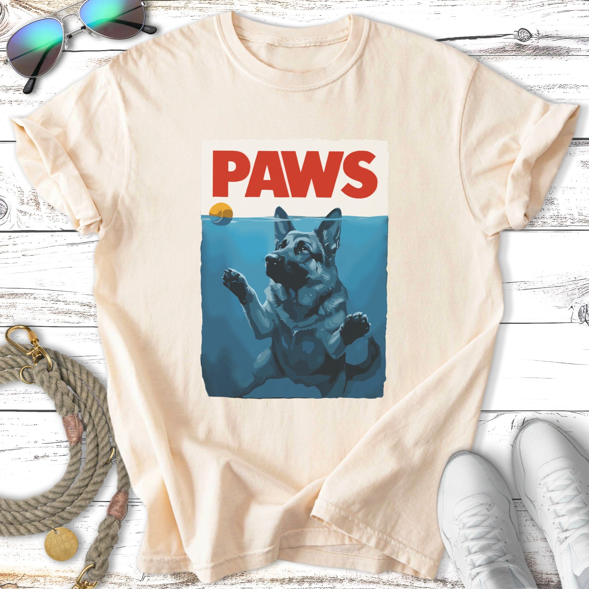 German Shepherd dog in water with "PAWS" text.