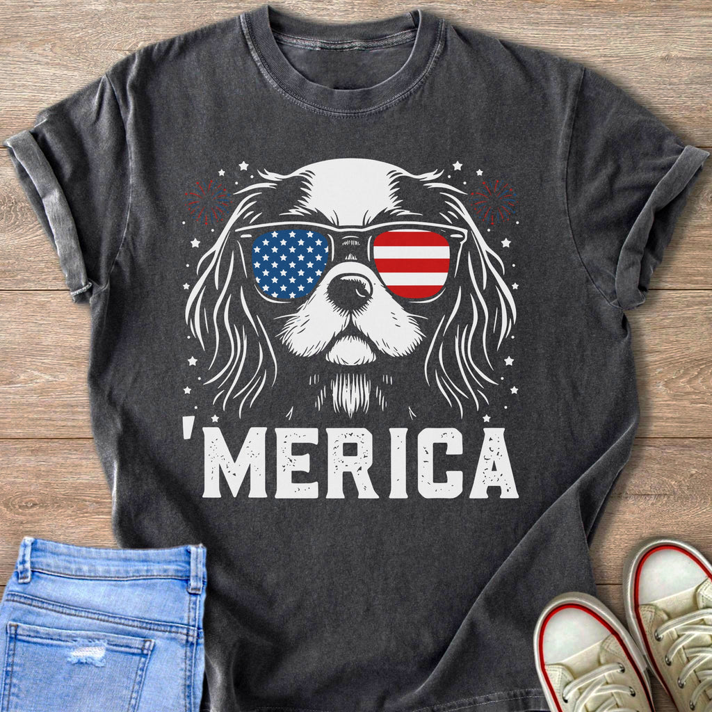 Dog wearing American flag sunglasses and text 'MERICA on t-shirt.